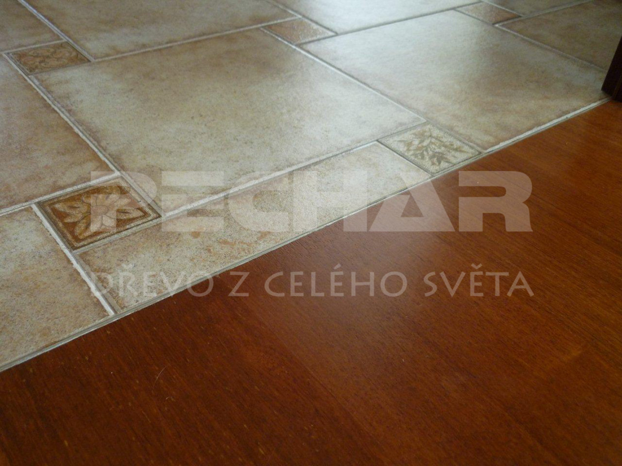 Merbau solid flooring lacquered surface, detail of the cut between wood and ceramic tiles